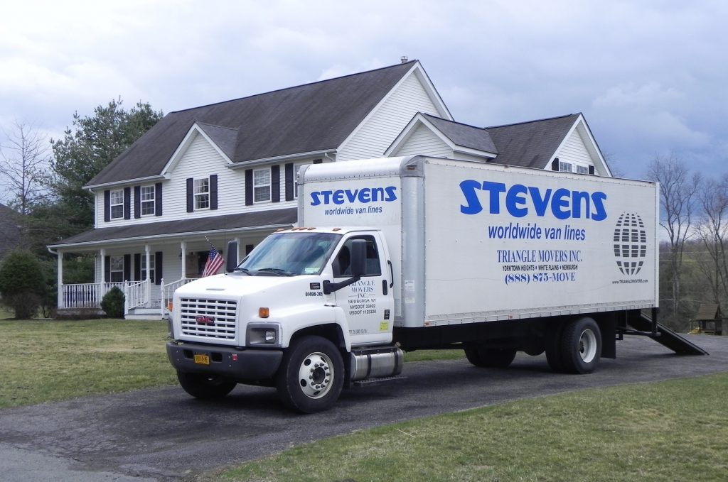 stevens worldwide and triangle movers truck outside house