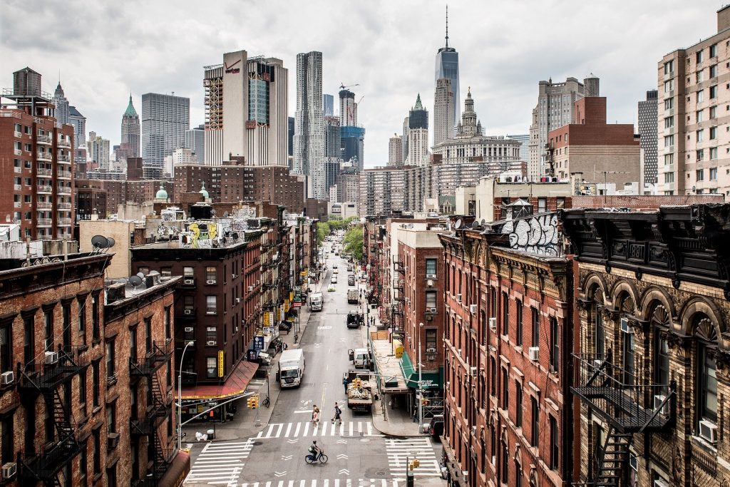 Manhattan skyline. Bustling street with buildings lining the sides.