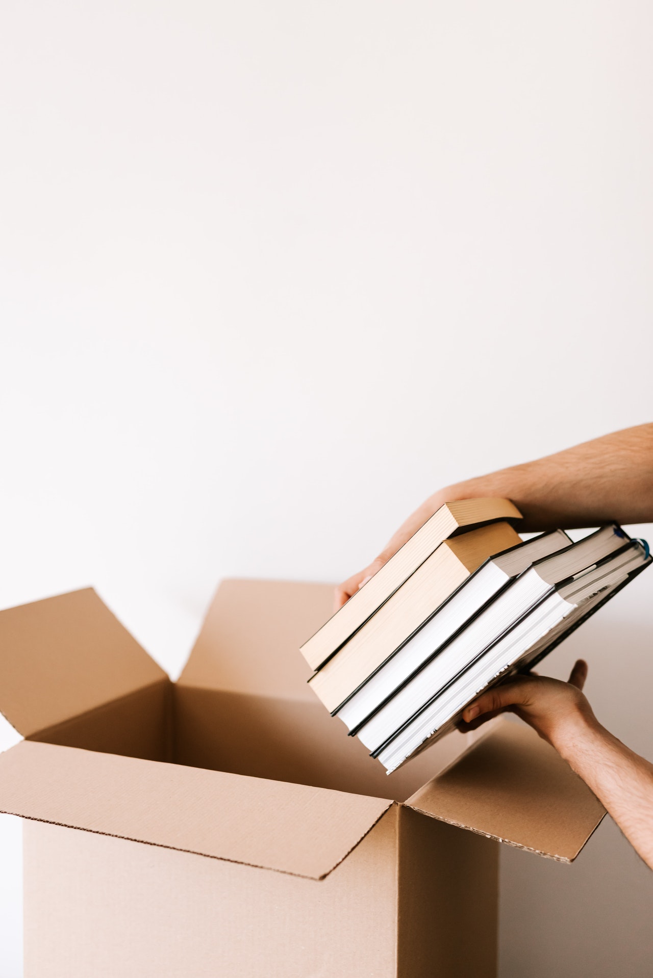 placing books in a moving box