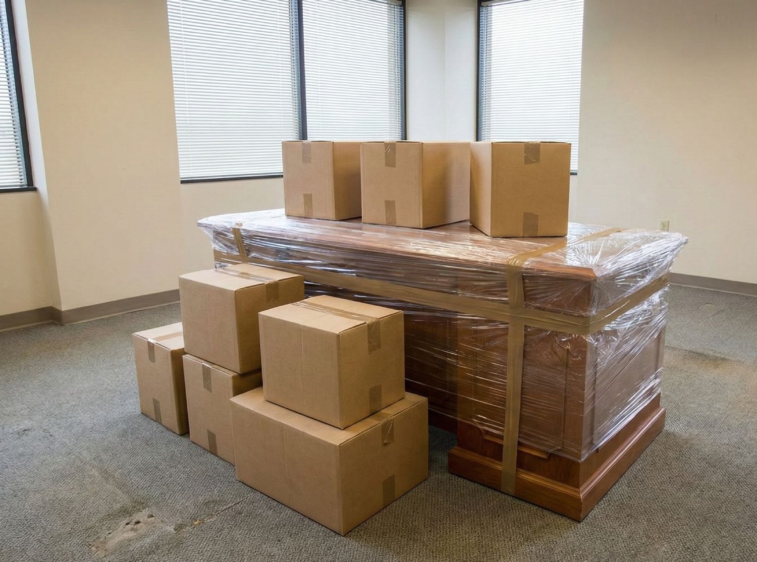 Desk wrapped in plastic with boxes